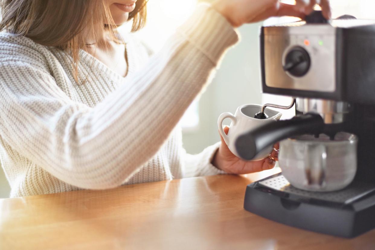 woman making coffee in machine