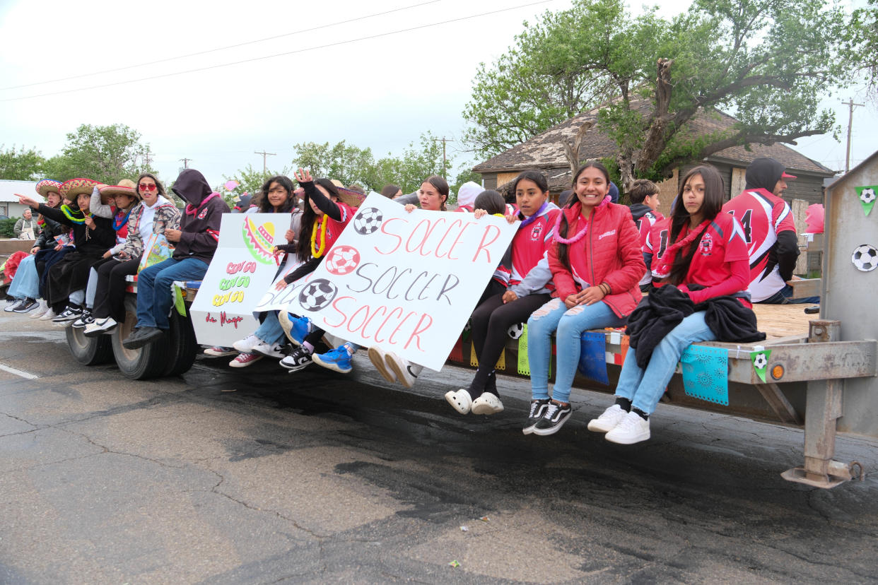A youth soccer team rides past the crowd Saturday at the annual Cinco de Mayo Parade Amarillo.