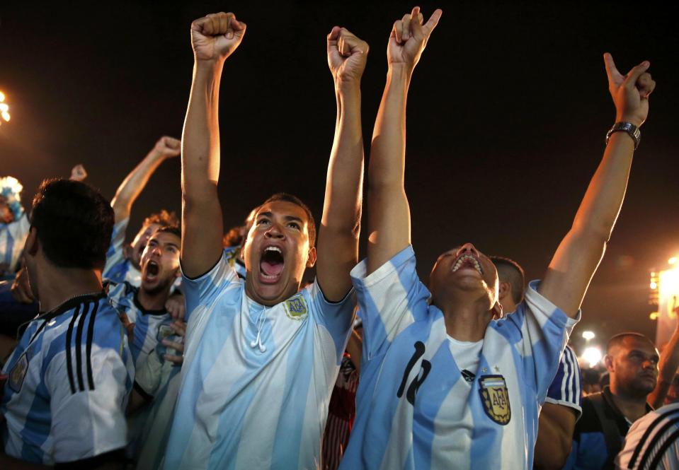 Argentinian soccer fans react during the penalty shootout as they watch a broadcast of the 2014 World Cup semi-final against the Netherlands at Copacabana beach in Rio de Janeiro, July 9, 2014. REUTERS/Pilar Olivares