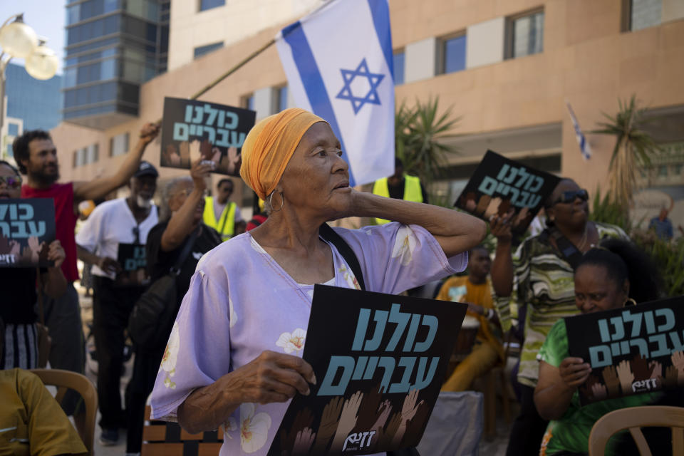 Members of the African Hebrew Israelites of Jerusalem rally outside of the District Court in Beersheba, Israel, ahead of a hearing on the deportation orders for dozens from their community, Wednesday, July 19, 2023. The community's decades-long plight to secure their status shines a light on Israel's strict immigration policy, which grants people whom it considers Jewish automatic citizenship but limits entry to others who don't fall within that definition. (AP Photo/Maya Alleruzzo)