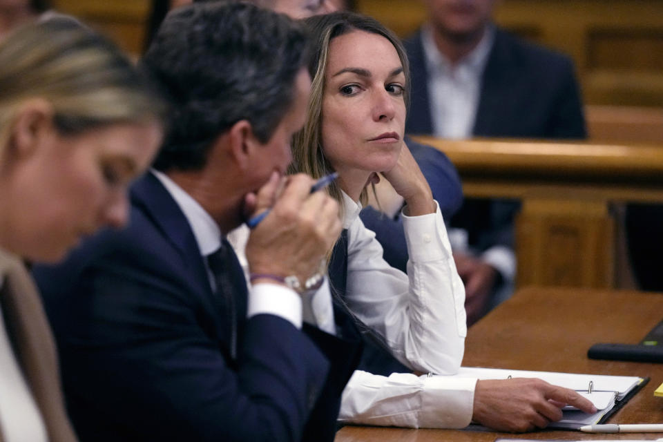 Defendant Karen Read, right, talks with her attorney Alan Jackson during her trial in Norfolk Superior Court, Friday, June 14, 2024, in Dedham, Mass. Read, 44, is accused of running into her Boston police officer boyfriend with her SUV in the middle of a nor'easter and leaving him for dead after a night of heavy drinking. (AP Photo/Charles Krupa, Pool)