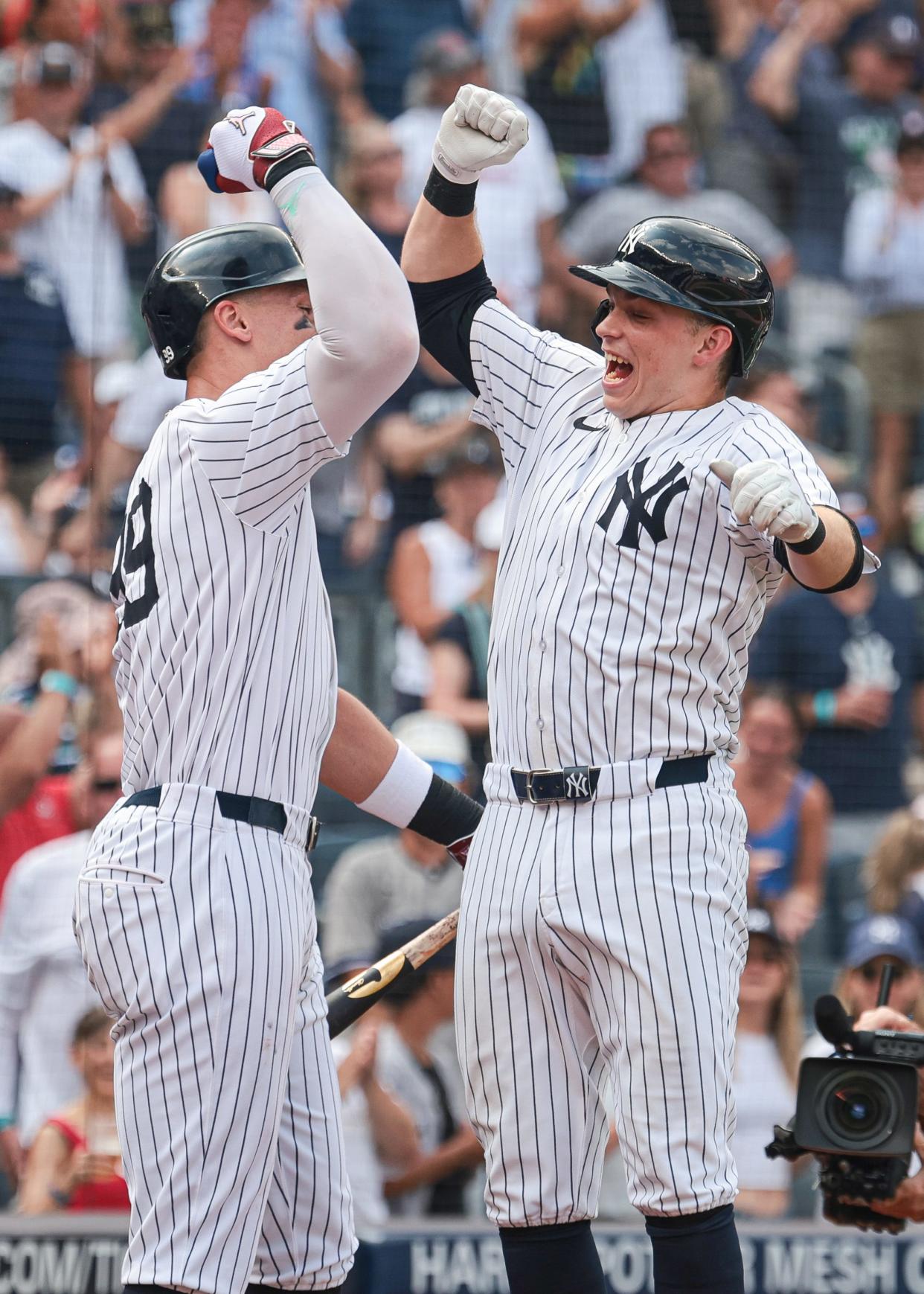 Jul 6, 2024; Bronx, New York, USA; New York Yankees first baseman Ben Rice (93) celebrates after his third home run of the game, a three run home run, with center fielder Aaron Judge (99) during the seventh inning against the Boston Red Sox at Yankee Stadium. Mandatory Credit: Vincent Carchietta-USA TODAY Sports