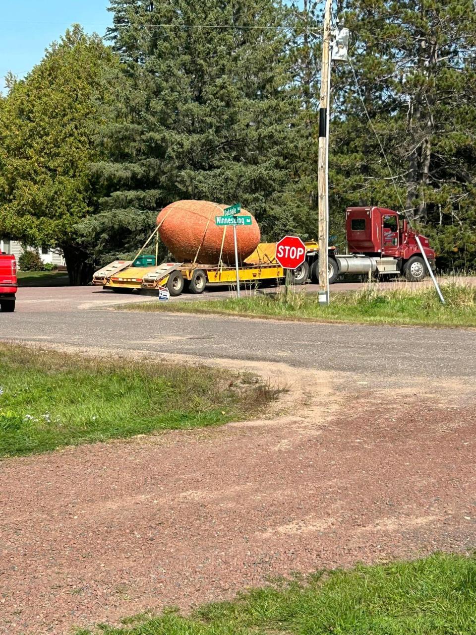 A flat-bed tractor-trailer truck from Walt Moss Trucking moved the giant ball of twine to the Highland town hall site.