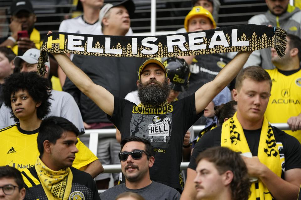 A Crew fan holds a Hell is Real scarf during a game against Cincinnati last year.