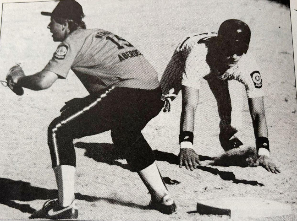 Watertown Post 17 base runner Heath Rylance dives back into first base as Aberdeen first baseman Kevin Mentzer awaits the throw during their American Legion Baseball doubleheader in 1980 at Watertown Stadium.
