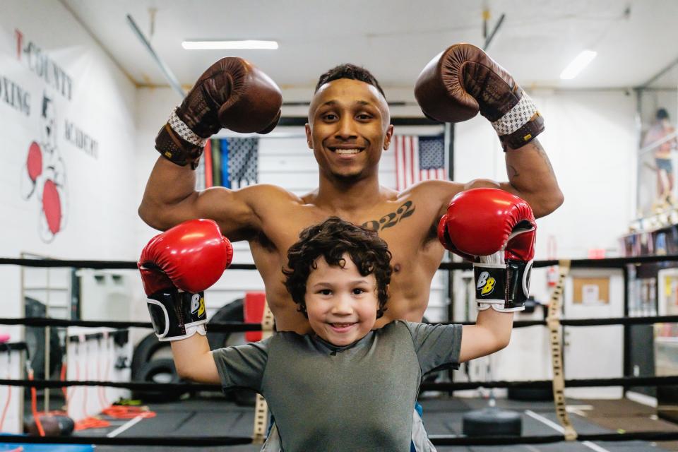 Professional boxer Andre Donovan poses with his son, Kyson Valentine, 6,  at T-County Boxing Academy, Thursday evening, March 16 in New Philadelphia.