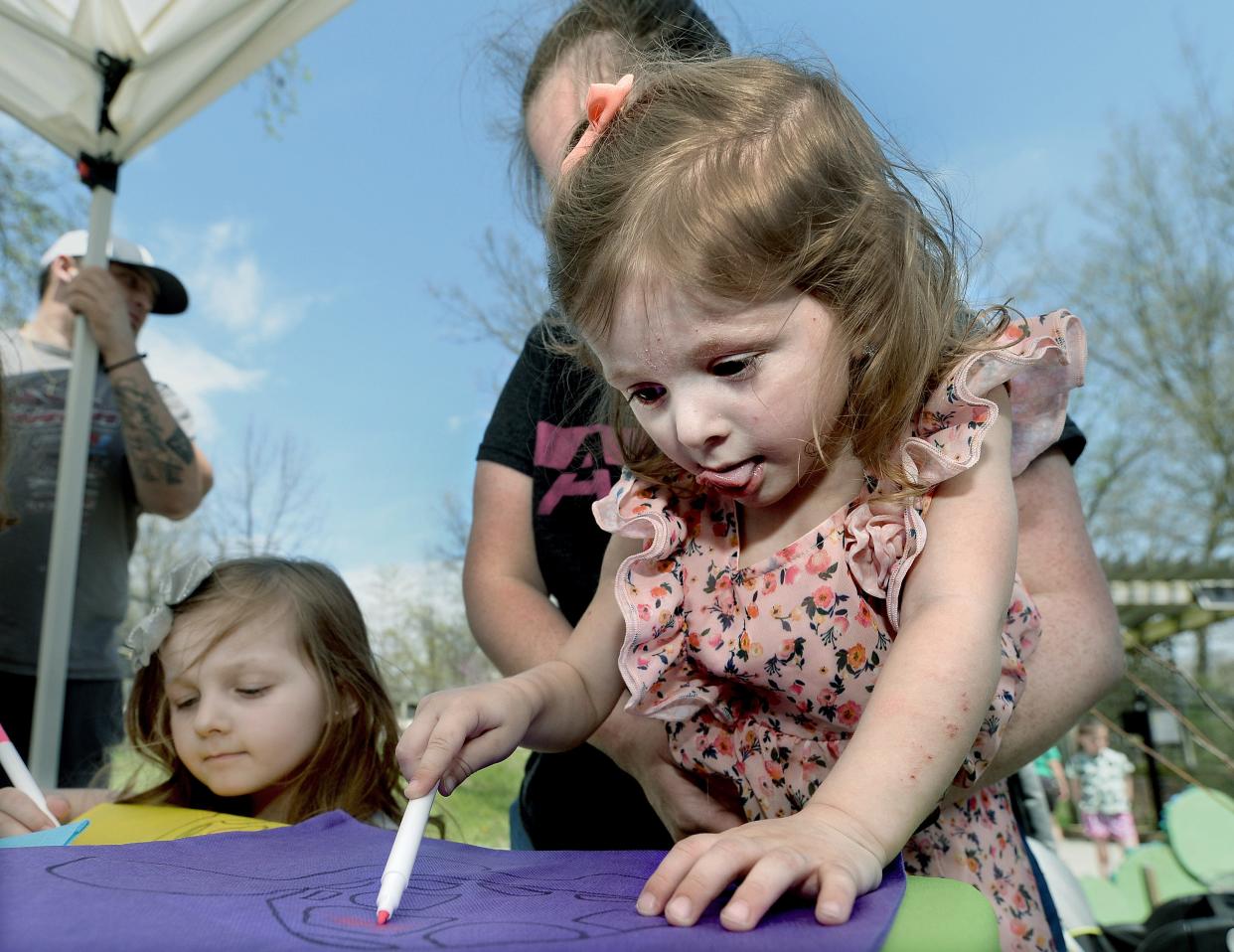 Wrigley Mahler, 2, of Springfield colors a turtle image onto a reusable tote bag during an Earth Awareness Fair at the Henson Robinson Zoo in Springfield Saturday April 23, 2022. [Thomas J. Turney/ The State Journal-Register]