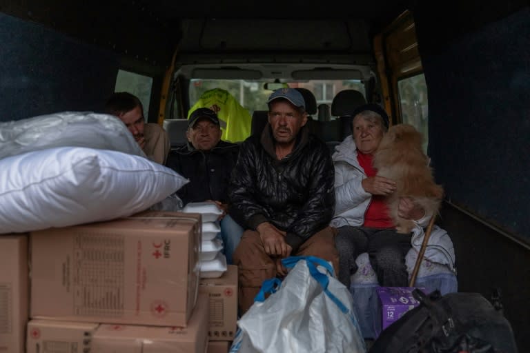 Evacuees from the village of Lyptsi, wait in a minivan at an evacuation point in Kharkiv as Russia presses its offensive (Roman PILIPEY)