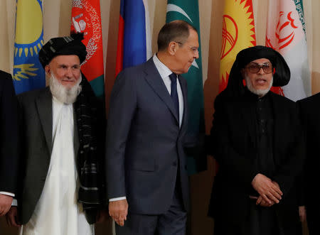 Head of Afghanistan delegation and Deputy Chairman of High Peace Council, Hajji Din Mohammad, Russian Foreign Minister Sergei Lavrov and Sher Mohammad Abbas Stanakzai, head of the Taliban’s political council in Qatar, pose for a family photo during the multilateral peace talks on Afghanistan in Moscow, Russia November 9, 2018. REUTERS/Sergei Karpukhin