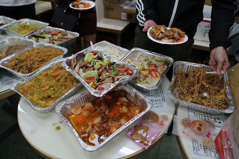 Protesters serve themselves with free Christmas dinner offered by a local restaurant in Hong Kong