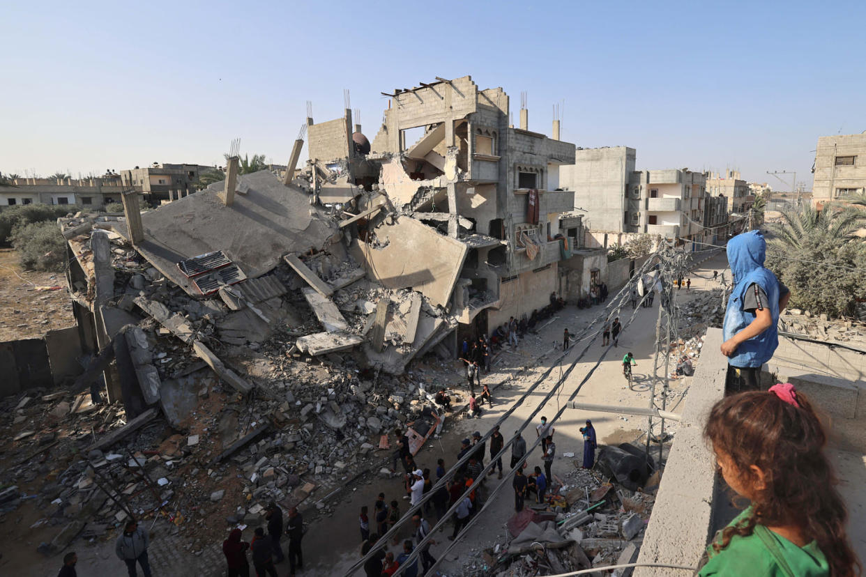 Young Palestinians stand on a rooftoop overlooking the destruction in Rafah in the southern Gaza, on April 2, 2024, following overnight Israeli bombardment. (Mohammed Abed / AFP - Getty Images)