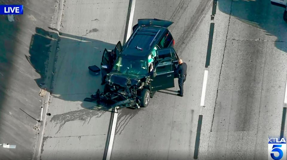 This photo from KTLA-TV video shows a Los Angeles police officer at the scene following a pursuit of a hearse on Interstate 110 in south Los Angeles on Feb. 27 after it was stolen late Wednesday.