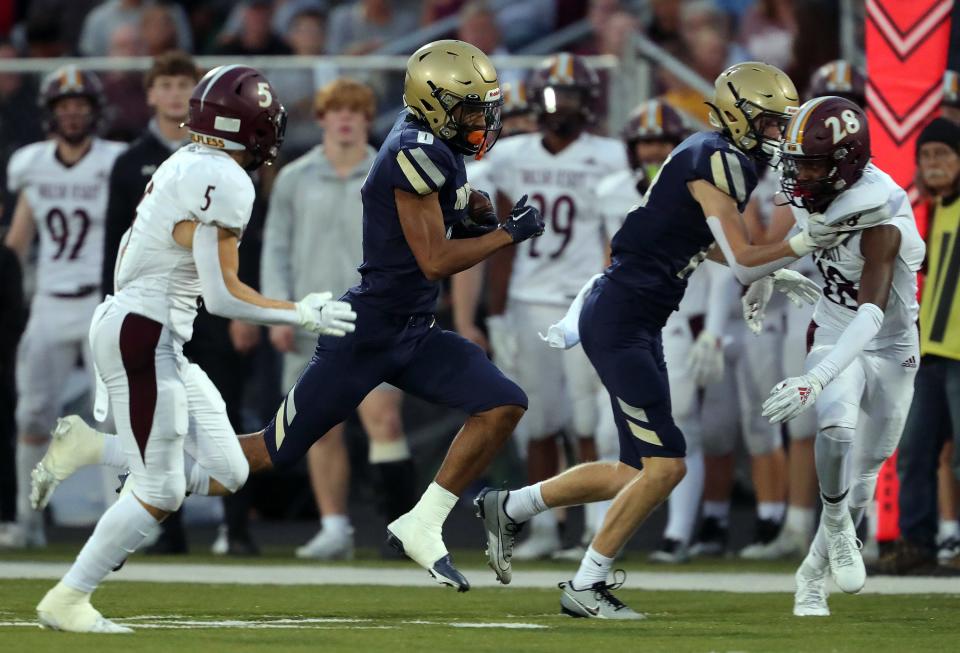 Hoban wide receiver Payton Cook runs for yards after a catch against Walsh Jesuit during the first half Friday in Akron.