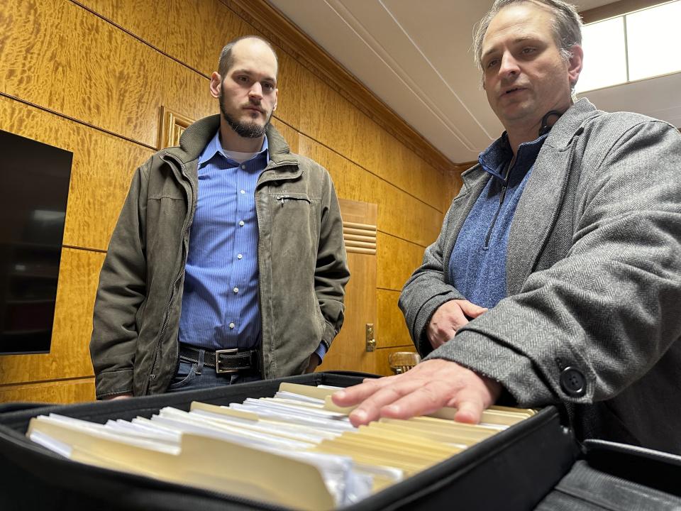 FILE - Retire Congress North Dakota Chairman Jared Hendrix, left, and U.S. Term Limits National Field Director Scott Tillman look over petitions they submitted for a North Dakota congressional age limit ballot initiative, Feb. 9, 2024, at the state Capitol in Bismarck, N.D. On Wednesday, April 3, a top legislative panel unanimously approved a $1 million cost estimate for the state to defend the age limit proposed in a constitutional initiative approved for the June 11 ballot. (AP Photo/Jack Dura, File)