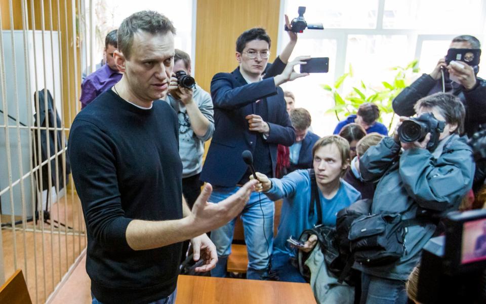 Alexei Navalny speaks to reporters in court on Monday morning - Credit:  Denis Tyrin/AP