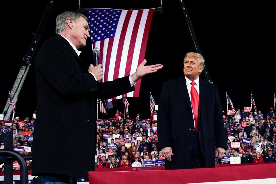 Georgia gubernatorial candiate David Perdue speaks as President Donald Trump looks on at a campaign rally.