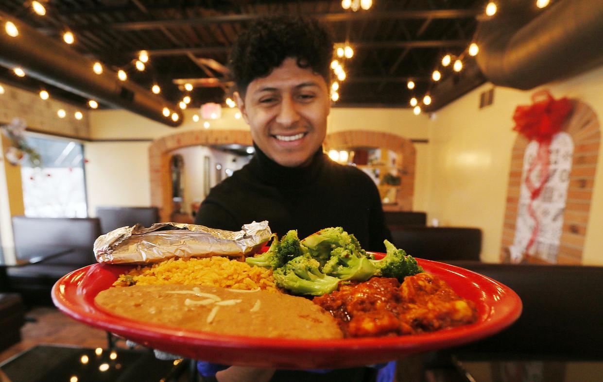 Jesus Frias, co-owner of Celaya Tex-Mex restaurant, shows their signature dish Camarones a La Diabla. Photo by Nirmalendu Majumdar/Ames Tribune