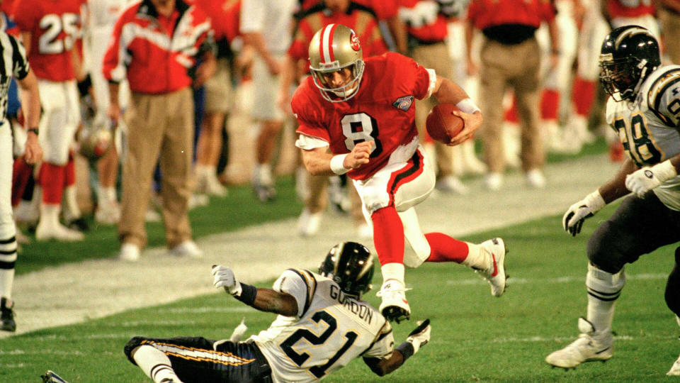 Young Gordon San Francisco 49ers' quarterback Steve Young (8) runs over San Diego's Darrien Gordon (21) for a first down during the first quarter of Super Bowl XXIX at Joe Robbie Stadium in Miami.