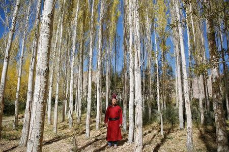 Tsering Gurmet, 28, a mountain guide, poses for a photograph in the village of Stok, 15 km from Leh, the largest town in the region of Ladakh nestled high in the Indian Himalayas, India September 28, 2016. When asked how living in the world's fastest growing major economy had affected his life, Gurmet replied: "Life has become much easier and much more comfortable although we are losing our traditions." REUTERS/Cathal McNaughton