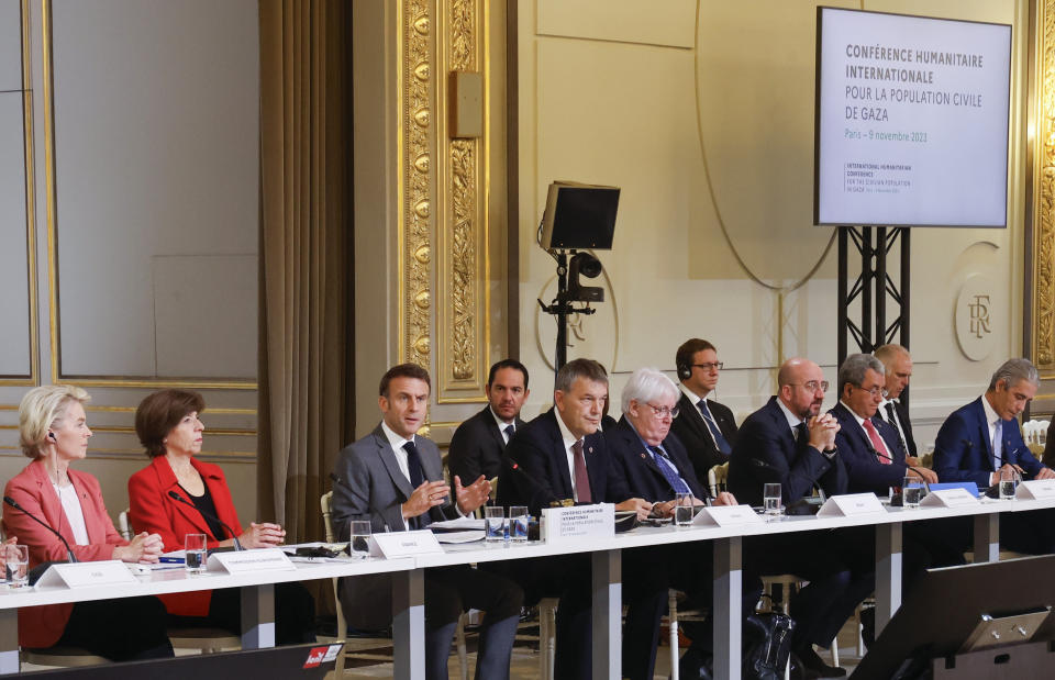 French President Emmanuel Macron, center, speaks during a meeting with officials from Western and Arab nations, the United Nations and nongovernmental organizations at the Elysee Palace, in Paris, Thursday, Nov. 9, 2023. Macron has opened a Gaza aid conference with an appeal for Israel to protect civilians, saying that "all lives have equal worth" and that fighting terrorism "can never be carried out without rules." (Ludovic Marin, Pool via AP)