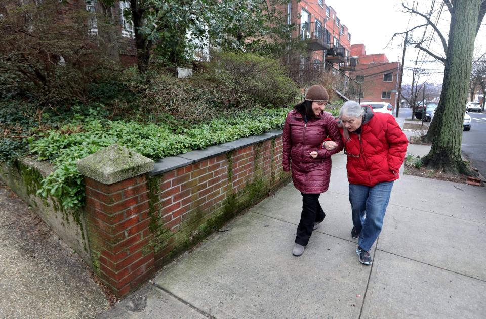 Maggie Ornstein takes her mother Janet for a walk in their Queens neighborhood on March 24 2022. Janet suffered a cerebral aneurysm in 1996 when Maggie was 17 years-old and suffered cognitive impairment. As a result, she has required constant caregiving ever since. Maggie, who holds a Phd. and three masters degrees, has spent her entire adult life living with and caring for her mother.