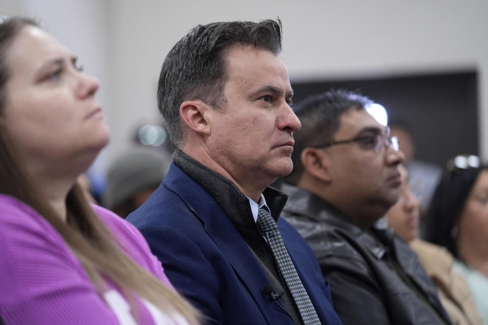 Texas State Sen. Roland Gutierrez, D-Texas, center, sits with family members of shooting victims as they listen to Attorney General Merrick B. Garland and Associate Attorney General Vanita Gupta during a news conference were they shared the findings of a federal report into the law enforcement response to a school shooting at Robb Elementary, Thursday, Jan. 18, 2024, in Uvalde, Texas. (AP Photo/Eric Gay)