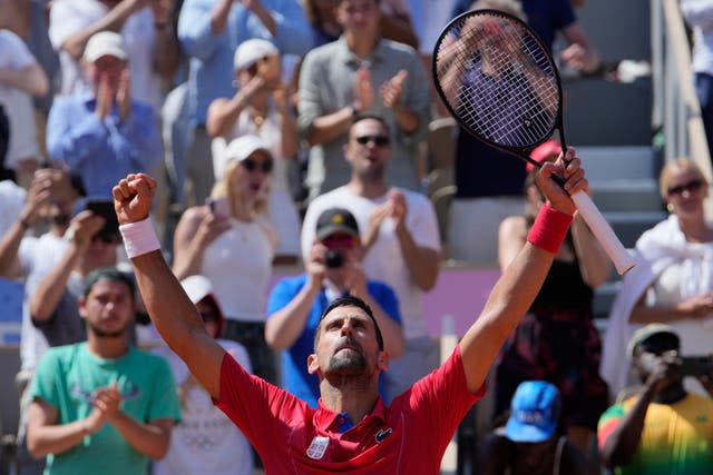 Novak Djokovic celebrates his victory by raising his arms above his head