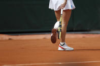 Denmark's Caroline Wozniacki tops the clay of her shoes during her first round match of the French Open tennis tournament against Russia's Veronika Kudermetova at the Roland Garros stadium in Paris, Monday, May 27, 2019. (AP Photo/Pavel Golovkin)