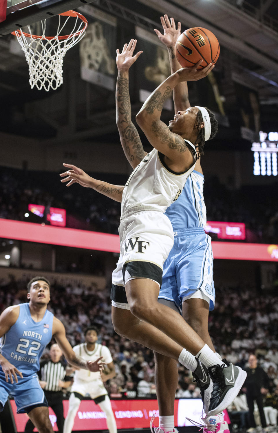 Wake Forest guard Alondes Williams (31) shoots over North Carolina forward Armando Bacot (5) during the first half of an NCAA college basketball game Saturday, Jan. 22, 2022, in Winston-Salem, N.C. (Allison Lee Isley/The Winston-Salem Journal via AP)