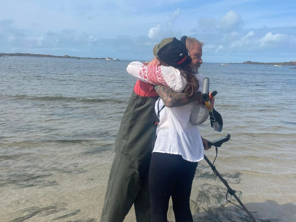 Tessa Le Gallez embraces detectorist Matthew Kneebone after he finds the chain in Guernsey. (SWNS)