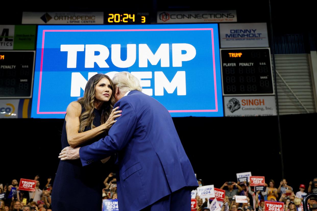 South Dakota Governor Kristi Noem greets former U.S. President and Republican presidential candidate Donald Trump before he speaks at a South Dakota Republican Party rally in Rapid City in 2023.