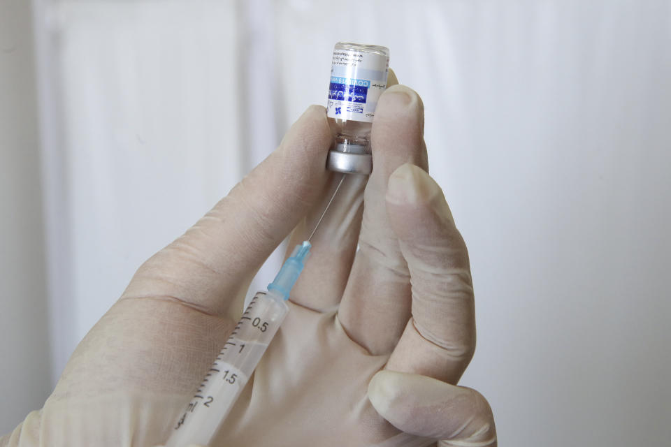 In this photo released by the official website of the office of the Iranian Presidency, a medic prepares a shot of the COVIran Barekat Covid-19 vaccine for President Ebrahim Raisi, in Tehran, Iran, Sunday, Aug. 8, 2021. On Sunday, Iran reported more new infections and deaths across the country than on any other single day since the pandemic began. In the face of U.S. sanctions that complicate banking transactions and deep-rooted suspicion of the West, Iran has vigorously promoted the local production of coronavirus vaccines, doling out the experimental COVIran Barekat vaccine to most healthcare workers. (Iranian Presidency Office via AP)