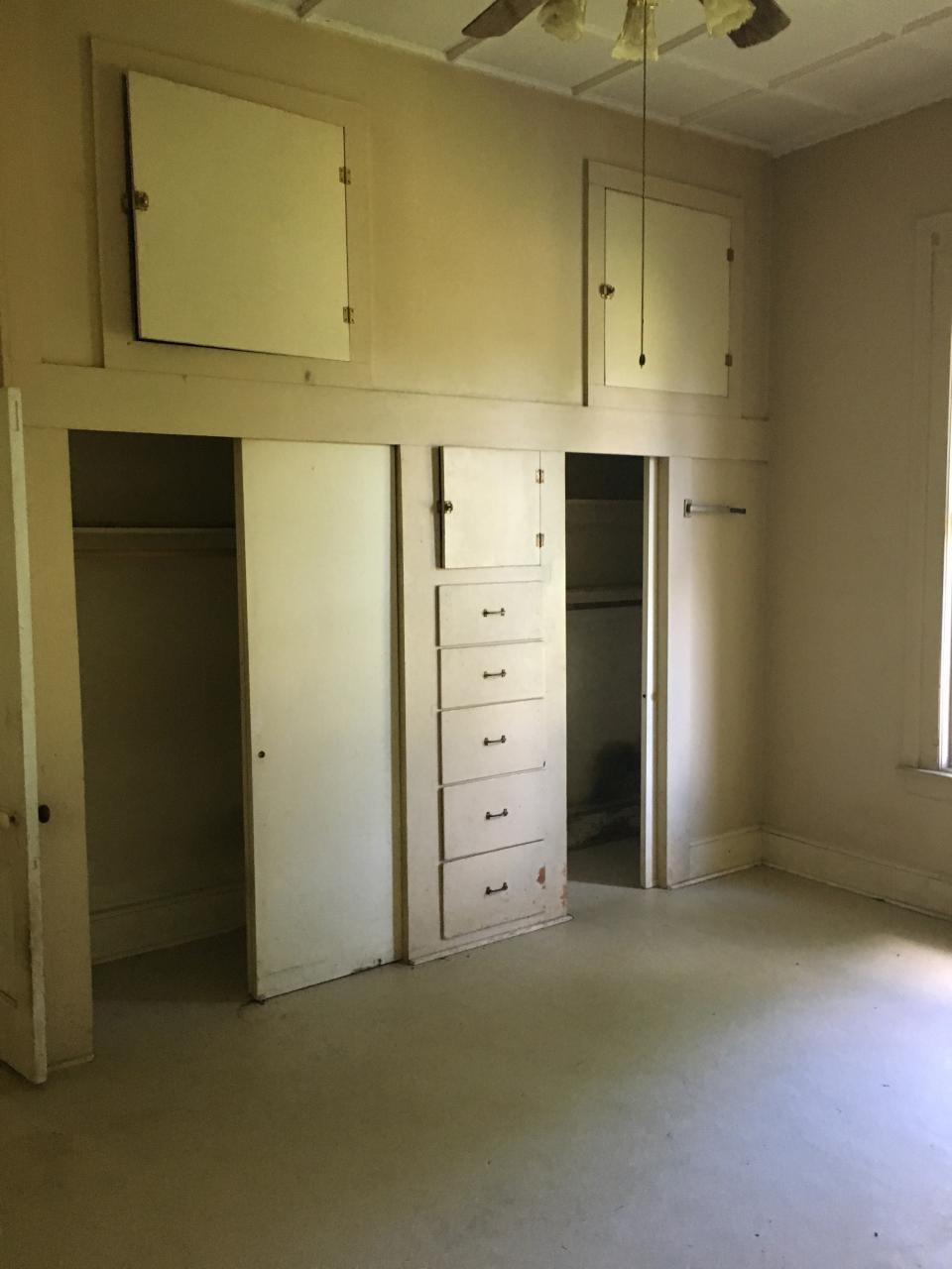 Massive closets and copious cubbies crowded the former playroom that would become the new kitchen.