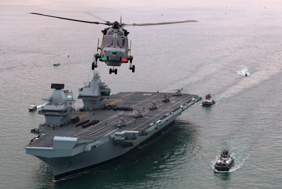 <em>A flotilla of craft followed the behemoth aircraft carrier (PA)</em>