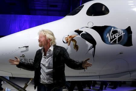 Richard Branson poses after unveiling the new SpaceShipTwo, a six-passenger two-pilot vehicle meant to ferry people into space that replaces a rocket destroyed during a test flight in October 2014, in Mojave, California, United States, February 19, 2016. REUTERS/Lucy Nicholson