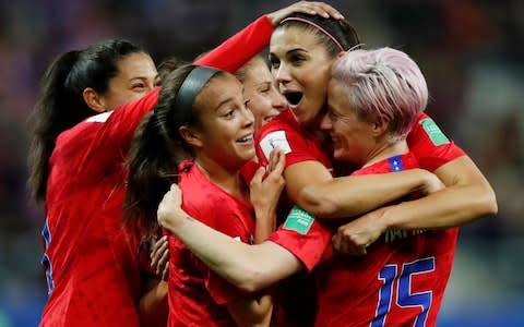 Alex Morgan is congratulated by her team-mates after equalling the record of her compatriot Michelle Akers for goals scored in a World Cup tie - Credit: reuters