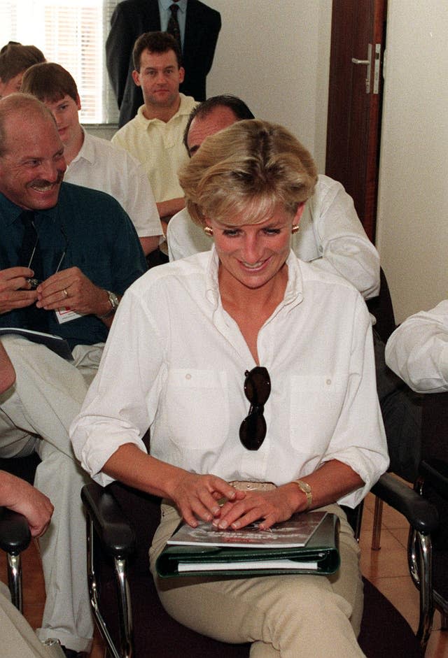 Diana, Princess of Wales, during a visit to Angola in January 1997, with her butler, Paul Burrell, seated two rows behind her (John Stillwell/PA)