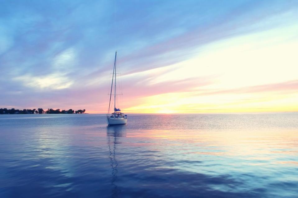 peaceful sailboat at sunset