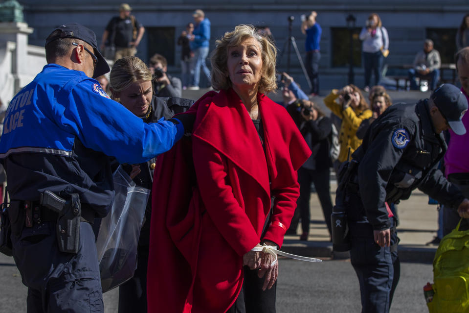 Actress Jane Fonda is checked by U.S. Capitol Police officers after being arrested during a rally on Capitol Hill in Washington, Friday, Oct. 18, 2019. A half-century after throwing her attention-getting celebrity status into Vietnam War protests, 81-year-old Jane Fonda is now doing the same in a U.S. climate movement where the average age is 18. (AP Photo/Manuel Balce Ceneta)