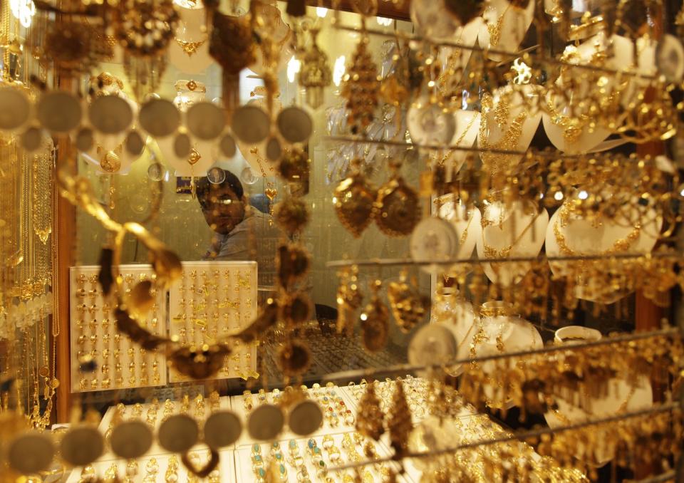 In this photo taken in Tuesday, Oct. 30, 2012, a jeweler waits for customers in Najaf, Iraq. The plunge in Iran's currency is proving bad for business in neighboring Iraq. Fewer Iranians are now able to afford visits to Shiite holy sites here and elsewhere in Iraq because each dollar or Iraqi dinar now costs roughly three times what it did as recently as last year. That has pushed the price of organized tours up sharply and made Iraqi merchants far less willing to accept rials as payment. (AP Photo/Khalid Mohammed)