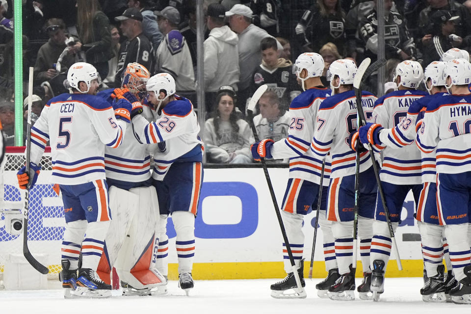 Edmonton Oilers defenseman Cody Ceci (5) and center Leon Draisaitl (29) congratulate goaltender Stuart Skinner (74) after the Oilers defeated the Los Angeles Kings 1-0 in Game 4 of an NHL hockey Stanley Cup first-round playoff series Sunday, April 28, 2024, in Los Angeles. (AP Photo/Mark J. Terrill)