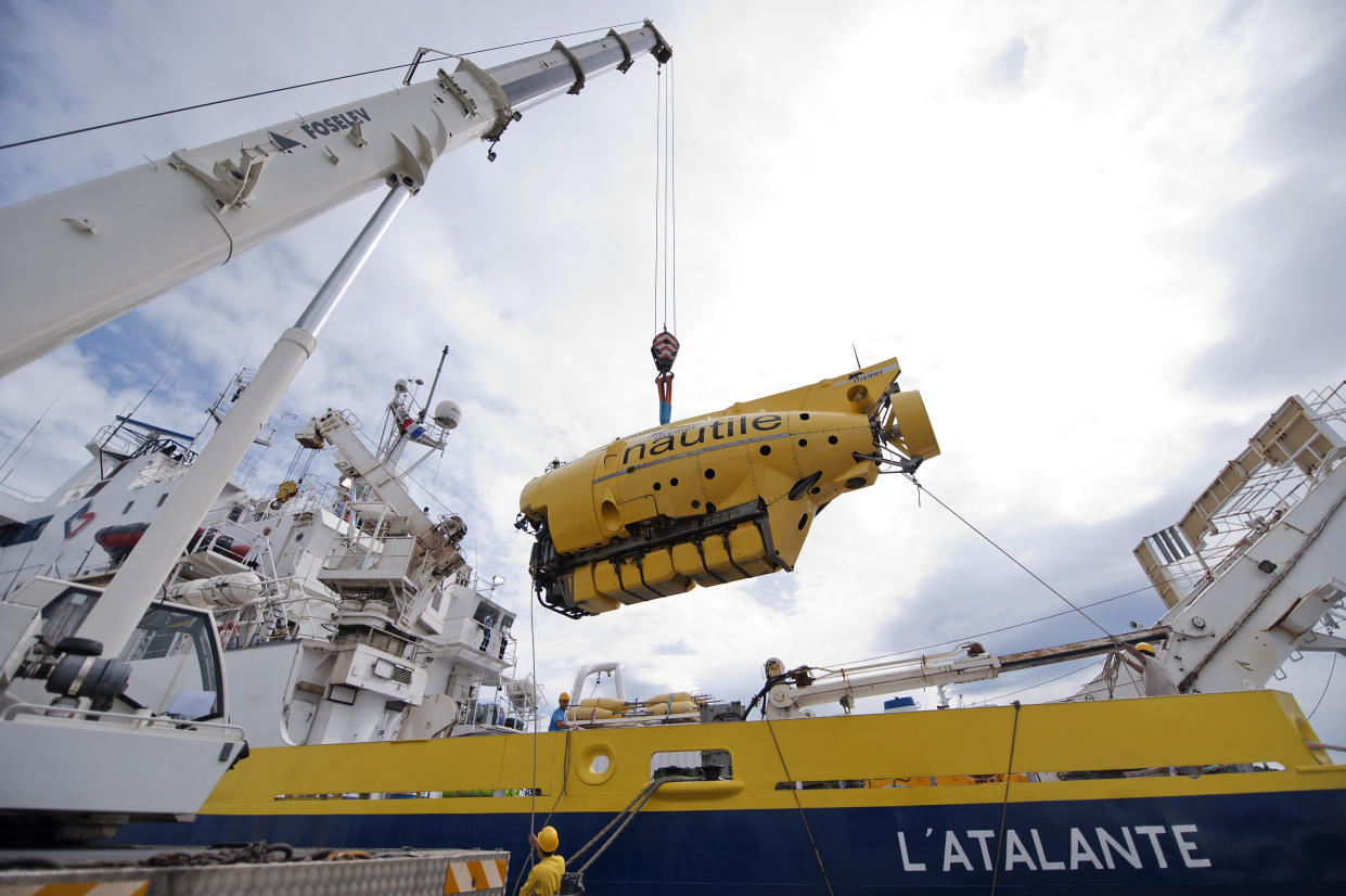French Research Institute for Exploration of the Sea (IFREMER) team loads a manned submarine, the Nautile, designed for observing ocean floors, on board the research vessel L'Atalante, on July 25, 2011 in La Seyne-sur-Mer, southern France. (Bertrand Languois/AFP via Getty Images)