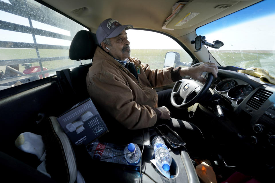 Rod Bradshaw drives down a dirt road as he goes to check on a field on his farm near Jetmore, Kan., Wednesday, Jan. 13, 2021. Bradshaw, who claims to be the last Black farmer in Hodgeman County, is concerned that systemic discrimination by government agencies, farm lenders and the courts have reduced the numbers of Black farmers in the United States from about a million in 1920 to less than 50,000 today. (AP Photo/Charlie Riedel)