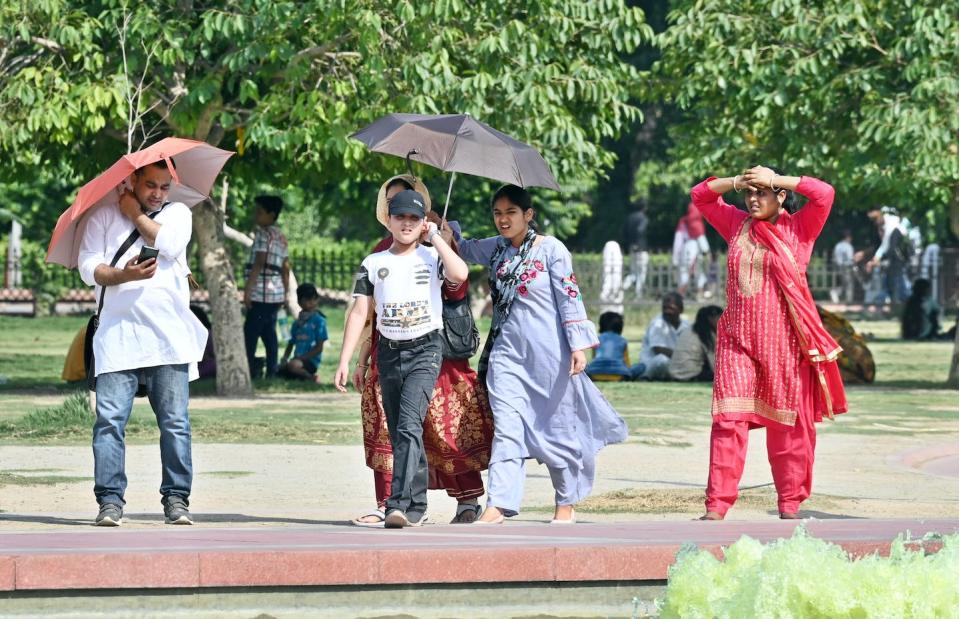 India saw sweltering temperatures in May and June 2023. <a href="https://www.gettyimages.com/detail/news-photo/people-out-at-india-gate-on-hot-afternoon-on-may-21-2023-in-news-photo/1256969460" rel="nofollow noopener" target="_blank" data-ylk="slk:Sanjeev Verma/Hindustan Times via Getty Images;elm:context_link;itc:0;sec:content-canvas" class="link ">Sanjeev Verma/Hindustan Times via Getty Images</a>