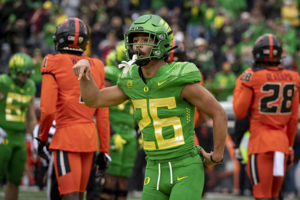 Oregon running back Travis Dye (26) celebrates a touchdown during the first quarter of an NCAA college football game against Oregon State, Saturday, Nov. 27, 2021, in Eugene, Ore. (AP Photo/Andy Nelson)