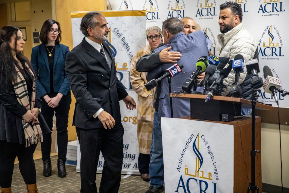 Zakaria Alarayshi hugs Arab American Civil Rights League (ACRL) Founder Nabih Ayad, while his family and other ACRL members look on after holding a press conference to share The Alarayshi’s experiences trying to make it out of the war zone in Gaza as U.S. citizens, at their offices in Dearborn on Wednesday, Nov. 8, 2023.