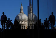 Workers are seen crossing the Millennium Bridge, with St Paul's Cathedral seen behind during the morning rush hour in London, Britain, September 25, 2018. REUTERS/Toby Melville