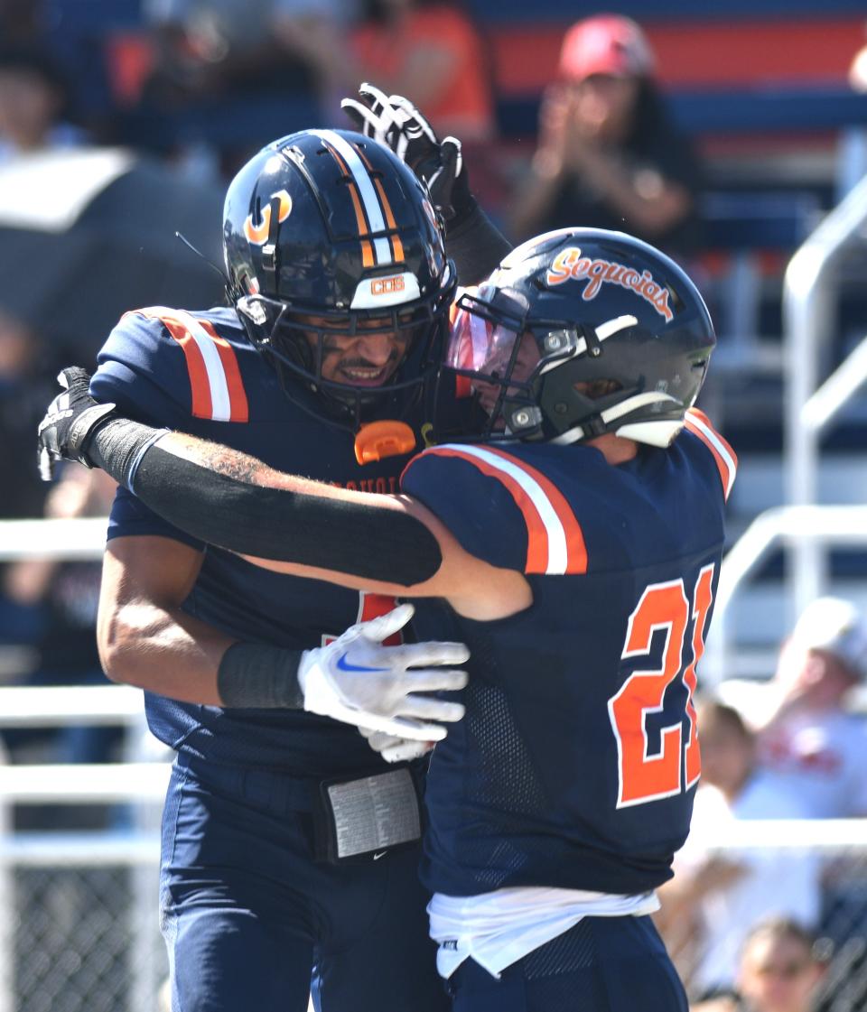 College of the Sequoias running back John Friend (23) celebrates with A.J. Dixon after scoring a touchdown in the first quarter against Fresno City on Oct. 14, 2023 at Sequoias Stadium in Visalia.