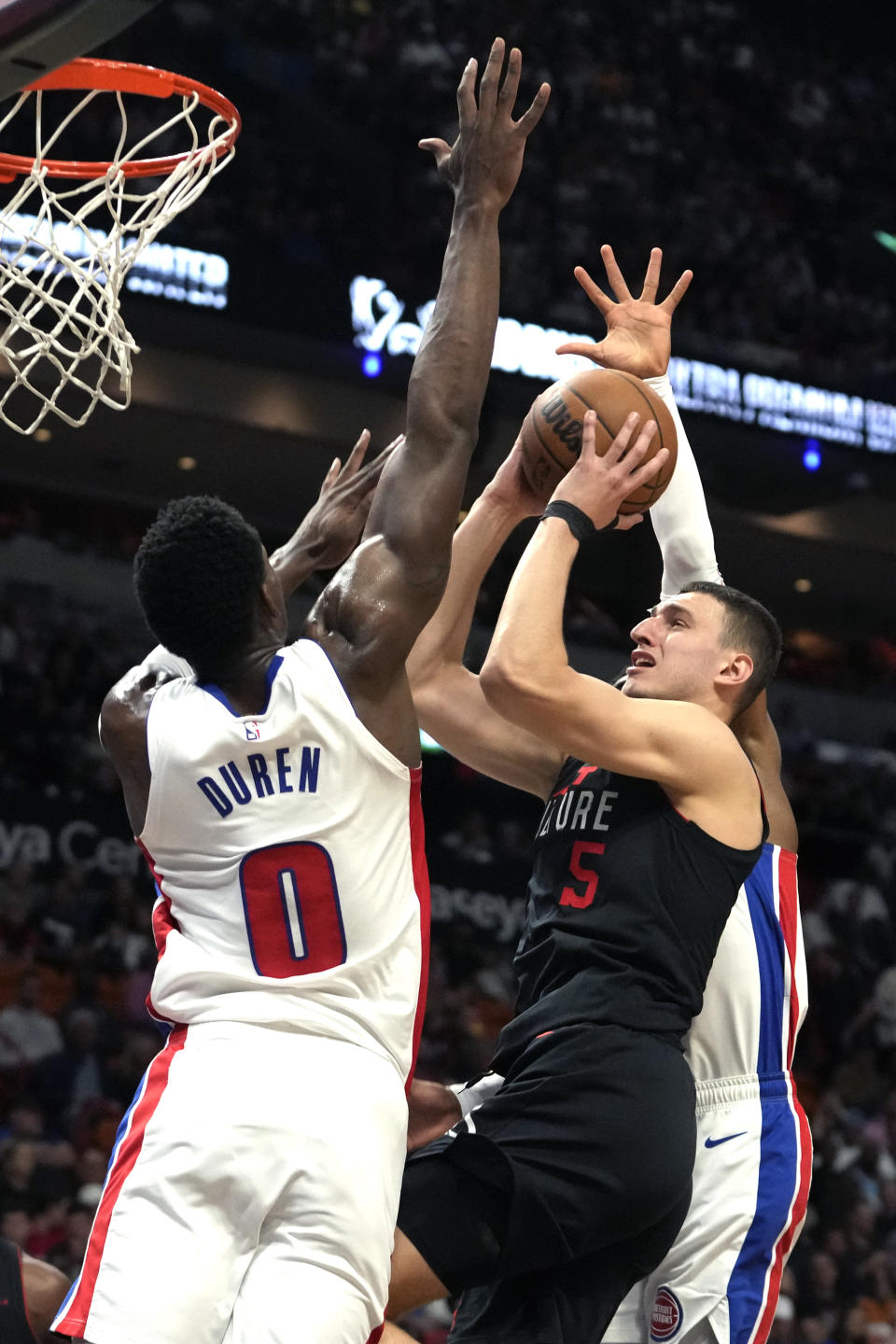 Miami Heat forward Nikola Jovic (5) goes to the basket as Detroit Pistons center Jalen Duren (0) defends during the first half of an NBA basketball game Tuesday, March 5, 2024, in Miami. (AP Photo/Lynne Sladky)