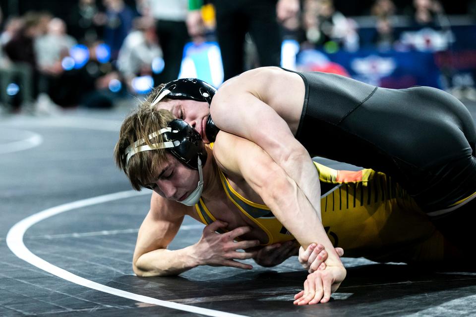 Iowa's Spencer Lee, top, wrestles Drake Ayala at 125 pounds in the finals during the Soldier Salute college wrestling tournament.